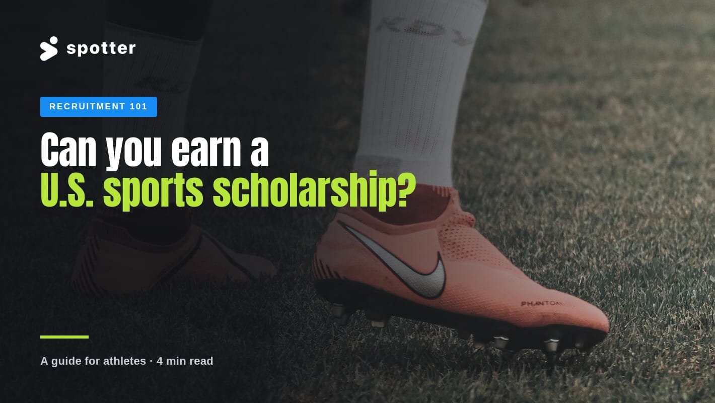 A player's cleats and white socks on a grass soccer field.